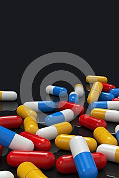 Colorful medicine capsules on black background, vertical