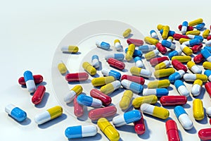 Colorful medicine capsules on light background