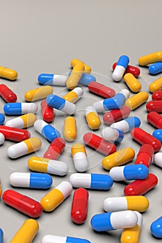 Colorful medicine capsules on light background