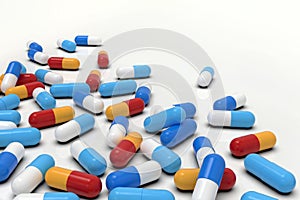 Colorful medicine capsules on white background, horizontal