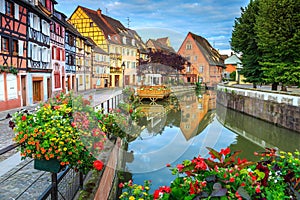 Colorful medieval half-timbered facades reflecting in water,Colmar,France