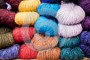 Colorful melange yarn balls on a shelf in a retail store