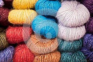 Colorful melange yarn balls on a shelf in a retail store