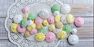 Colorful meringue cookies on napkin, natural light selective focus.