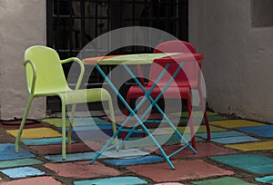 Colorful metal chairs and table in Spanish village in Balboa