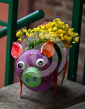 Colorful metal pig with yellow flowers