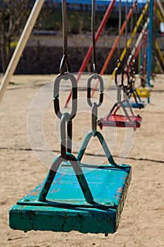 Colorful metal swings at a children's playground