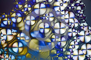 Colorful micro crystals in polarized light. Photo through a microscope