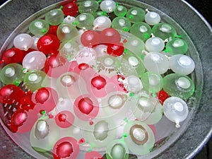 Colorful mini water balloons in galvanized bucket
