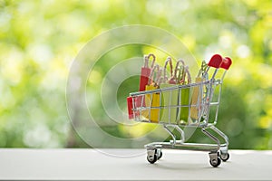 Colorful miniature shopping bags in cart