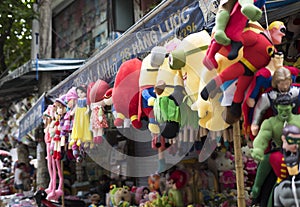 Colorful minions and superman puppets hanging for sale at an old street in Hanoi quarter streets