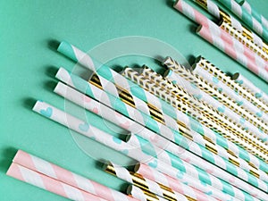 Colorful mint, pink and golden drinking straws for beverages