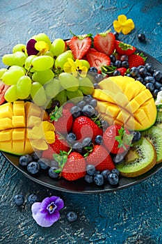 Colorful Mixed Fruit platter with Mango, Strawberry, Blueberry, Kiwi and Green Grape. Healthy food