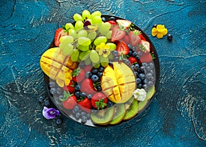 Colorful Mixed Fruit platter with Mango, Strawberry, Blueberry, Kiwi and Green Grape. Healthy food