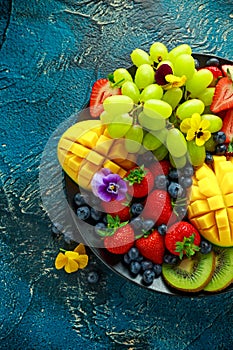 Colorful Mixed Fruit platter with Mango, Strawberry, Blueberry, Kiwi and Green Grape. Healthy food