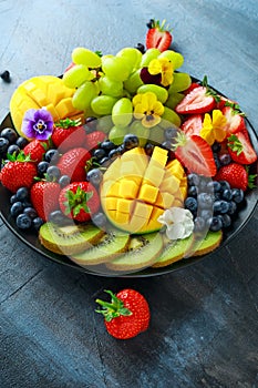 Colorful Mixed Fruit platter with Mango, Strawberry, Blueberry, Kiwi and Green Grape. Healthy food