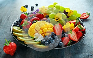 Colorful Mixed Fruit platter with Mango, Strawberry, Blueberry, Kiwi and Green Grape. Healthy food photo