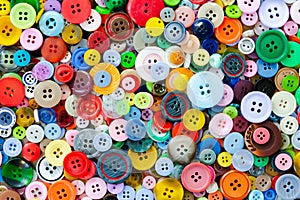 Colorful mixed sewing buttons background. Top view