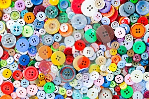 Colorful mixed sewing buttons background. Top view