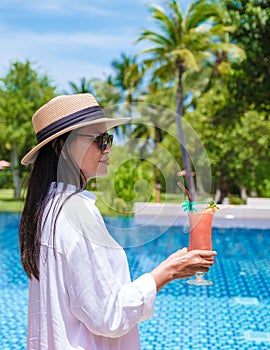 colorful mocktail at a pool bar, orange and green cocktail by the pool