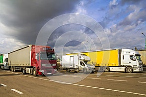 Colorful modern big semi-trucks and trailers of different makes