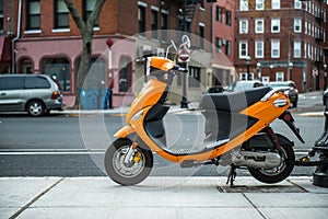 Colorful Moped locked up on city street. City transportation concept