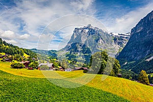 Colorful morning view of Grindelwald village valley from cableway. Wetterhorn and Wellhorn mountains, located west of