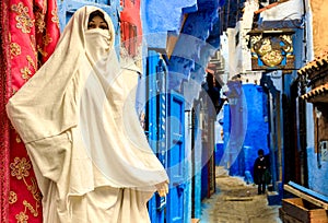 Colorful Moroccan fabrics and handmade souvenirs on the street in the blue city Chefchaouen, Morocco, Africa