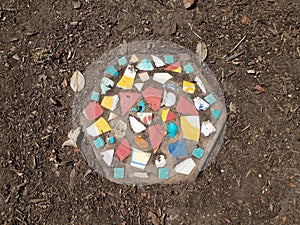 colorful mosaic stone tile in the ground or dirt