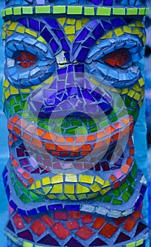 Colorful mosaic tile tiki man head detail pattern background