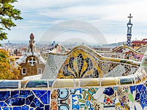 Colorful mosaics on fence of serpentine bench in Parc Guell