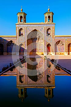 Colorful Mosque Nasir al Mulk in Shiraz. Reflection in water.