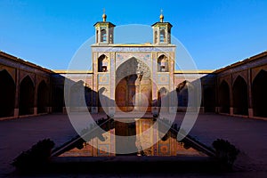 Colorful Mosque Nasir al Mulk in Shiraz. Reflection in water. Iran. Persia