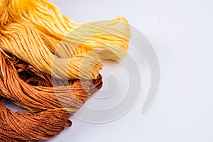 Bright colored skeins of floss threads on a white background