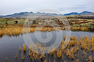 Colorful mountain landscape with autumn colors and icy lake