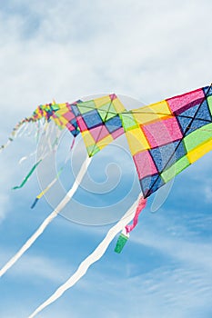 Colorful multi-color kites flying in blue sky