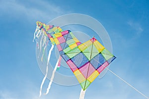 Colorful multi-color kites flying in blue sky