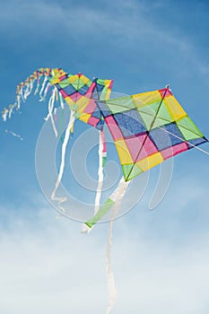 Colorful multi-color kites flying in blue sky