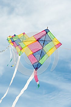 Colorful multi-color kites flying in blue sky