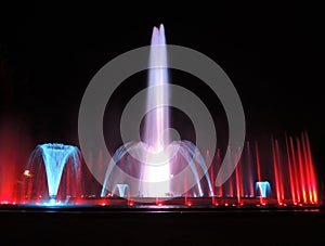 Colorful musical fountain. Magnificent night show of colorful lights, laser beams, music