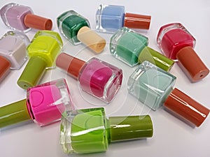 Colorful nail polish bottles arranged on a white background
