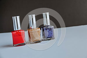 Colorful nail polish bottles on black and white background.