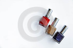 Colorful nail polish bottles on white. Beauty supplies