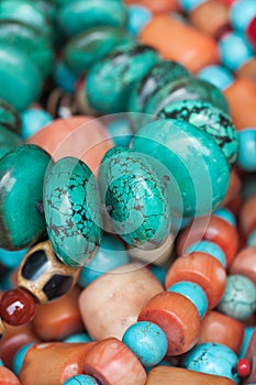 Colorful necklaces displayed on a flea market