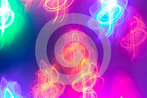 Colorful neon glowing treble clefs on bright purple background.
