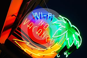 A colorful neon sign flashes no vacancy