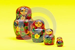 Colorful Nesting wooden Dolls isolated on bright yellow. National Russian souvenirs. Babushkas or Matryoshkas.