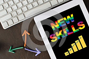 Colorful new skills word and rainbow lgbtq symbol growth graph on computer digital tablet with arrow and keyboard  on desk