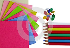 Colorful note papers pencils and pushpins on white