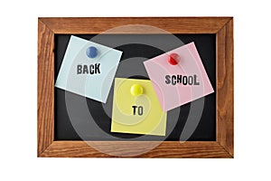 Colorful notepapers on magnetic blackboard with vintage text back to school isolated on white background